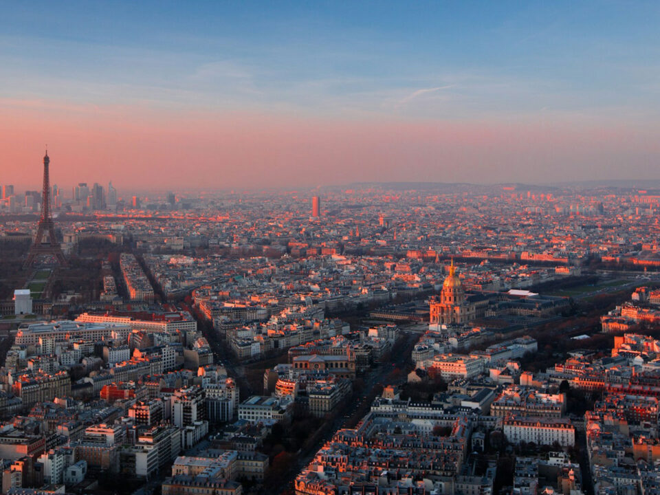 Paris skyline and the Eiffel Tower during sunset.